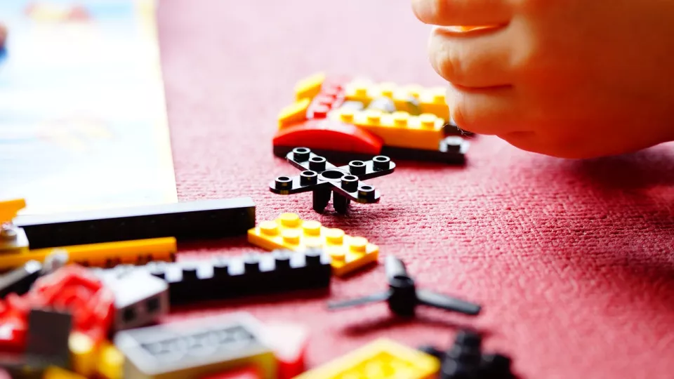 Lego and a child's hand. Photo. 