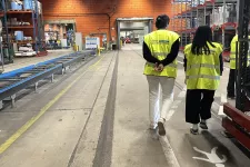 People in yellow vests at a factory