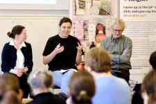 Three panelists and a crowd
