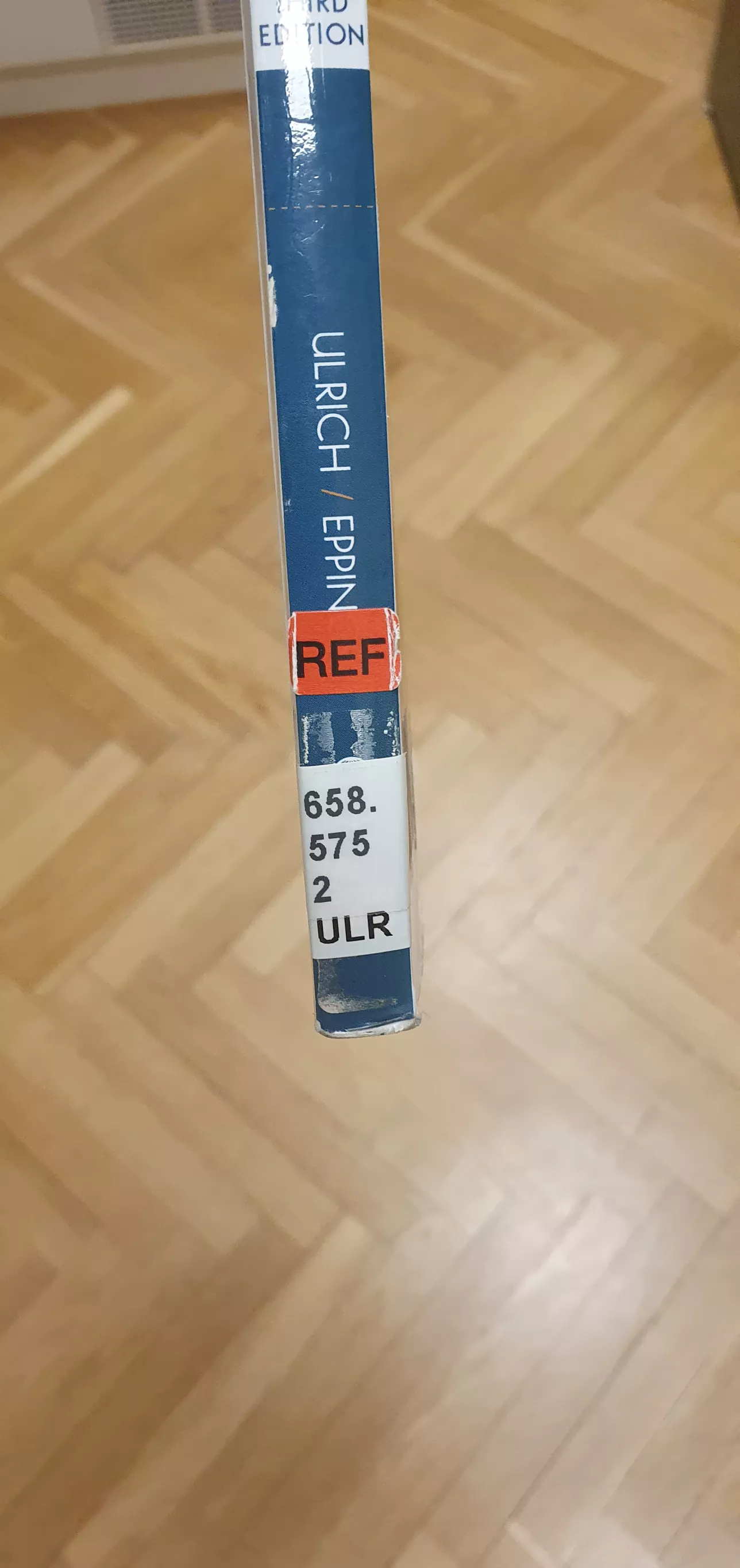 book spine with a red sticker reading ref as reference material