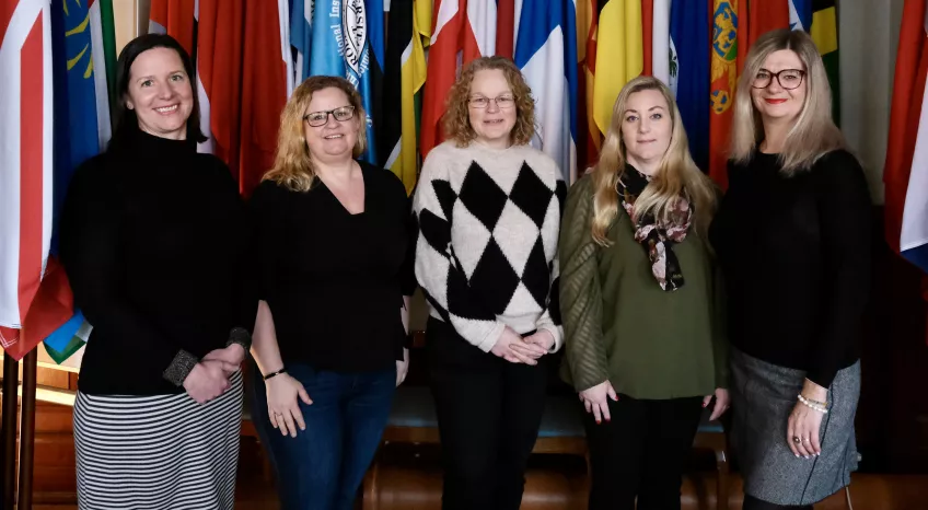 Group of people in front of flags